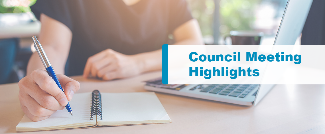 Person taking notes on a notebook with laptop in front. Text displays “Council Meeting Highlights.”
