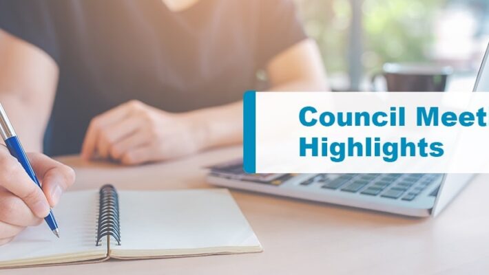 Person taking notes on a notebook with laptop in front. Text displays “Council Meeting Highlights”.